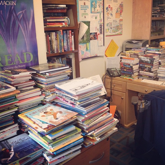 A desk, surrounded by books makes for a happy librarian!